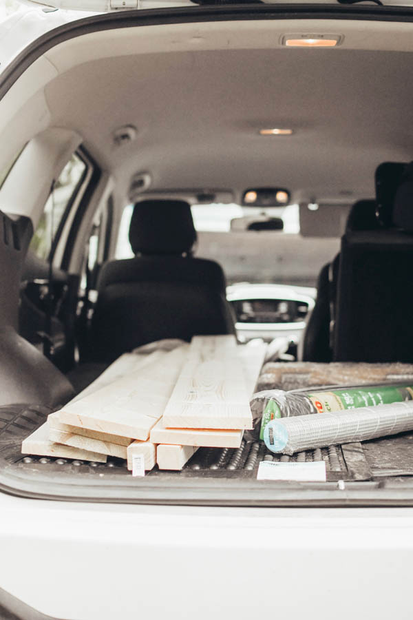 Pieces of wood in car for a raised garden bed