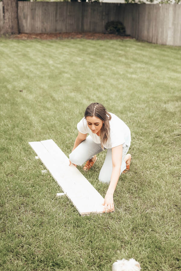 Girl matching up wood for a raised garden bed