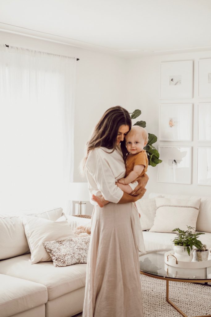 Mother Holding Baby In Living Room