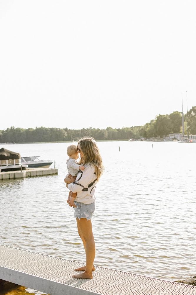 Girl on beach with a baby