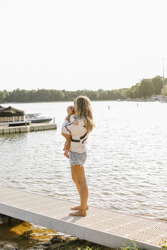 Girl on beach with a baby