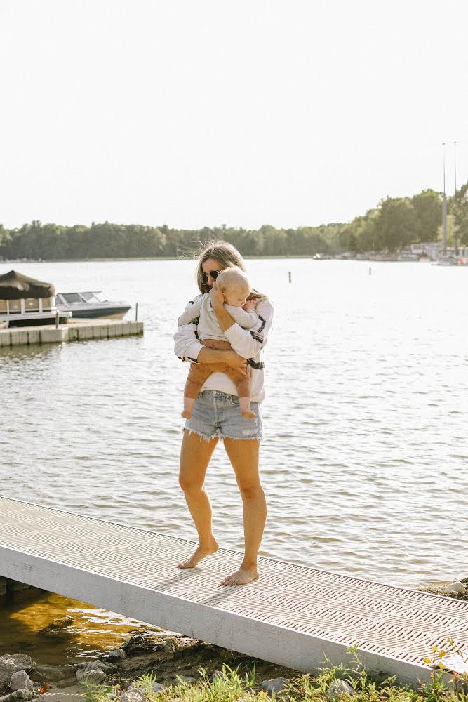 Girl on beach with a baby