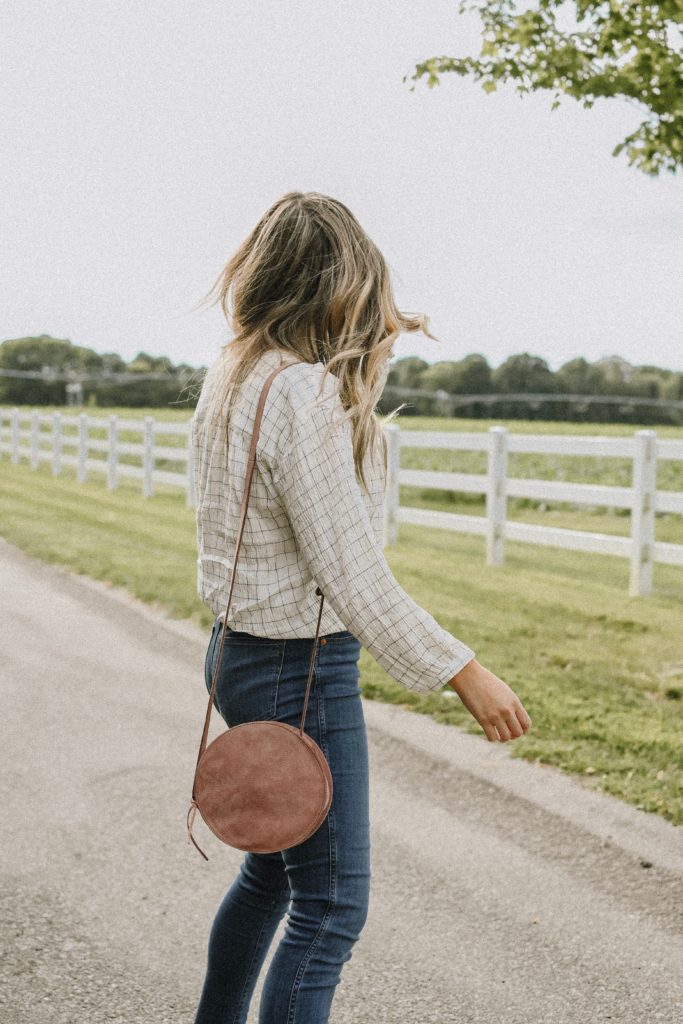 Girl by a white fence