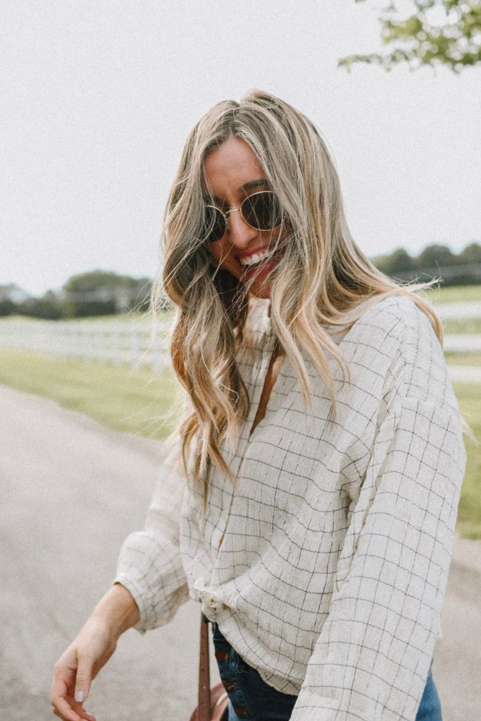 Girl by a white fence