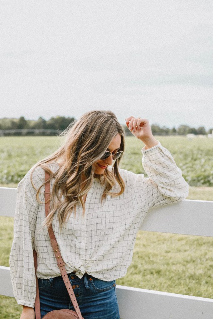 Girl by a white fence