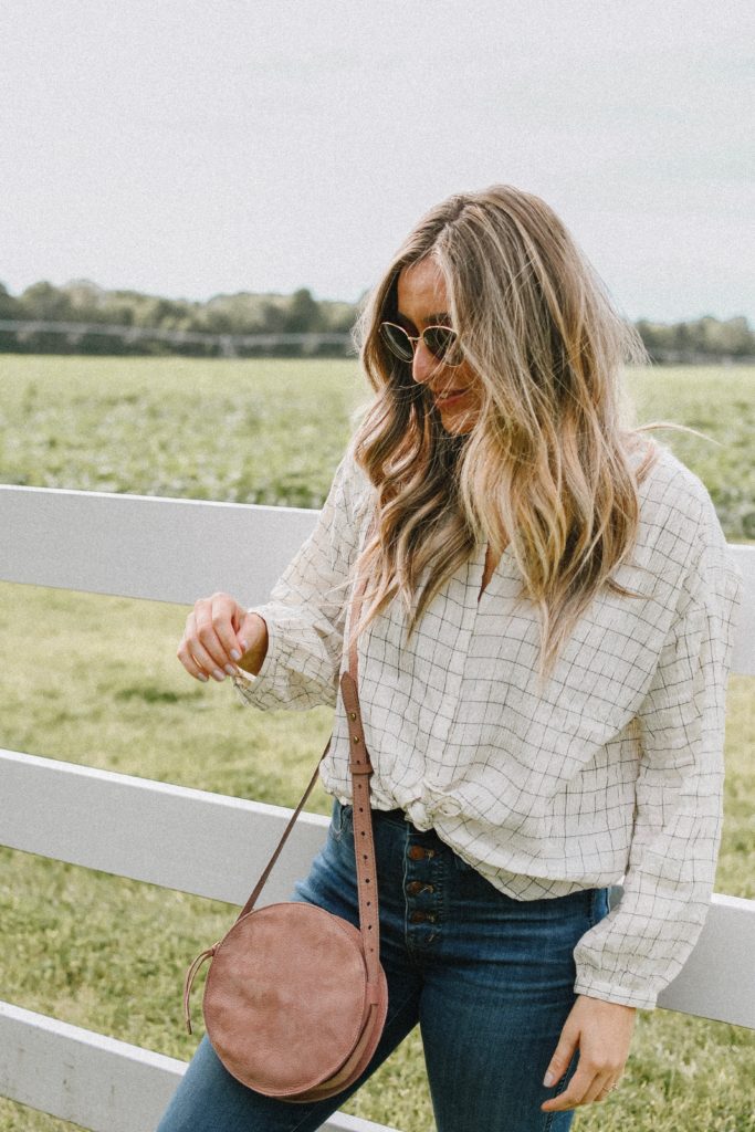 Girl by a white fence