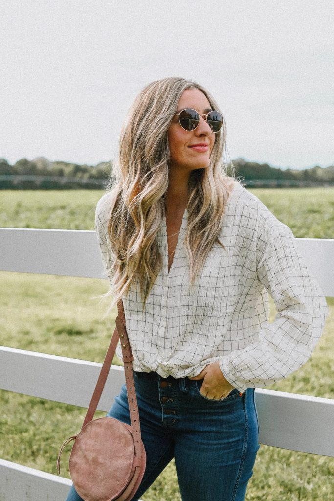 Girl by a white fence